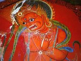 Tibet Guge 07 Tsaparang Red Temple 04 Red Mahakala Immediately to the left of the main door is an unusual red Mahakala, holding a chopper in his right hand, while his left hand is held in the threatening mudra at his heart. Photo - Bruno Baumann: Kristallspiegel. Pilgerreise zum heiligen Berg Kailash.